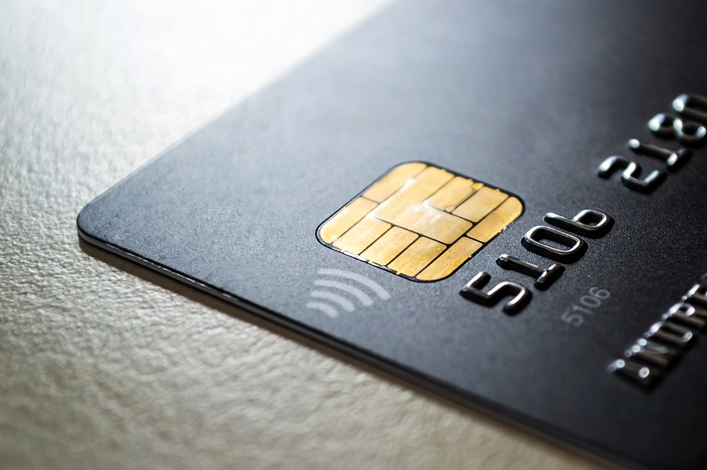Black credit card with chip and contactless pay technology.