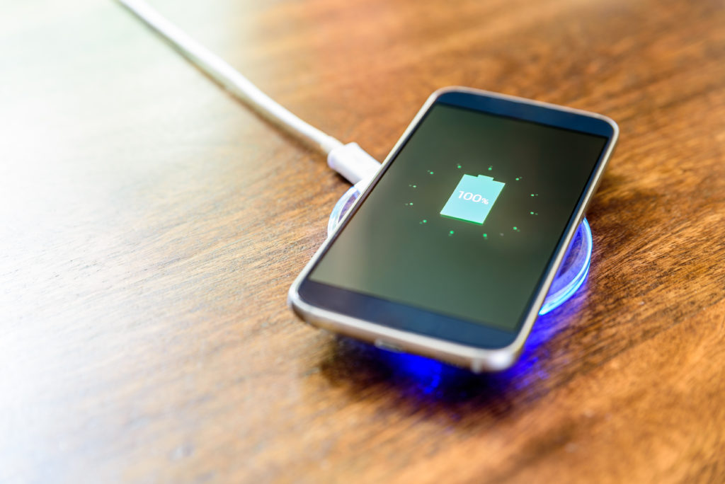 Smartphone charging on a wireless charger.