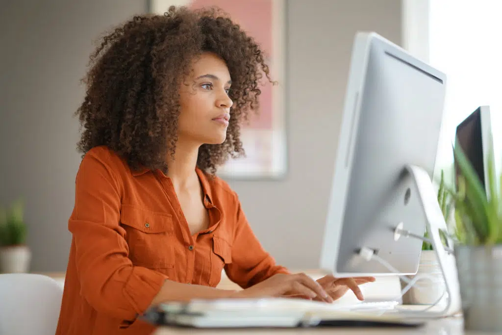 Businesswoman working on desktop computer.