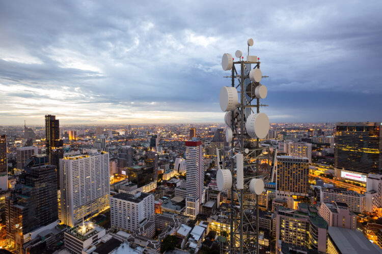 Telecommunication tower with 5G cellular network antenna in the evening.