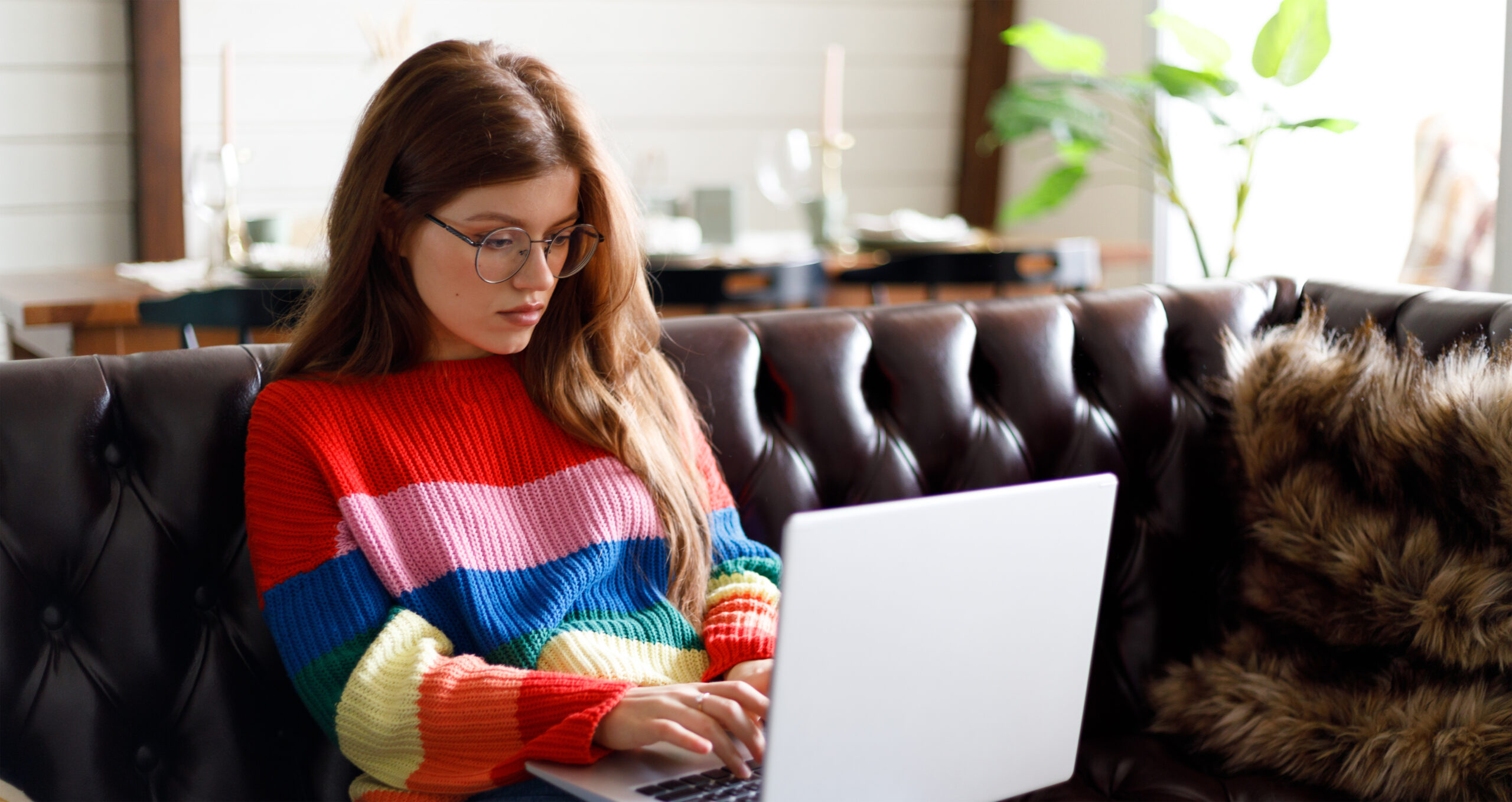 Young woman working on her laptop at home