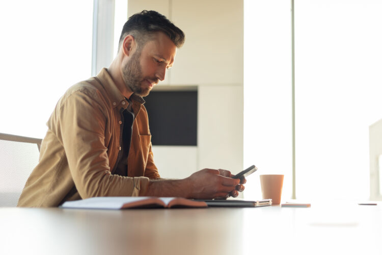 man using smartphone in office