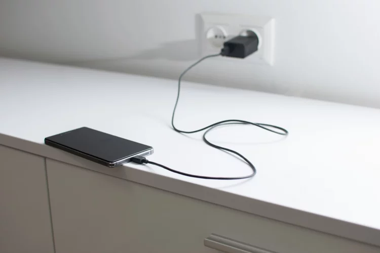 phone charging on top of drawer.