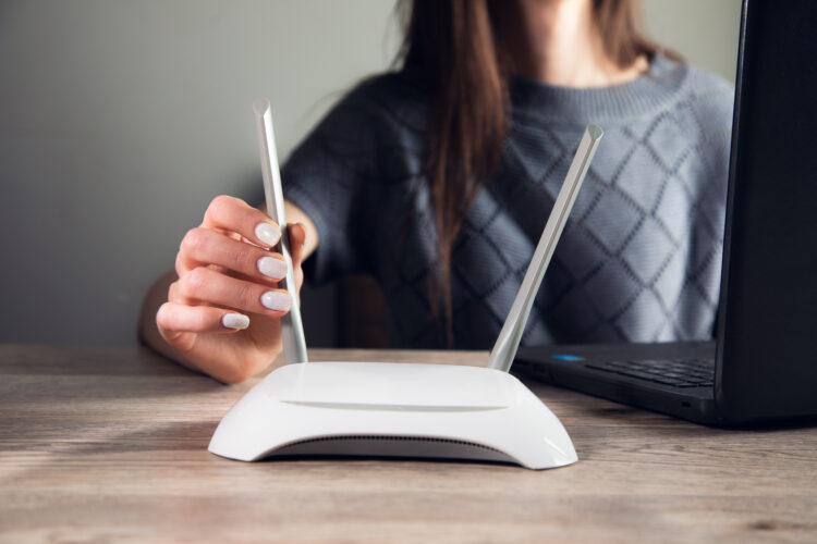 woman working in computer with wifi router