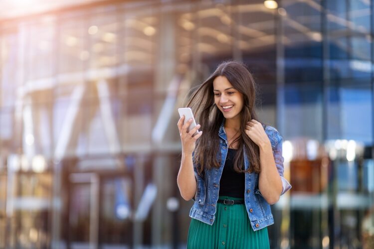 Young woman with smartphone in an urban city area