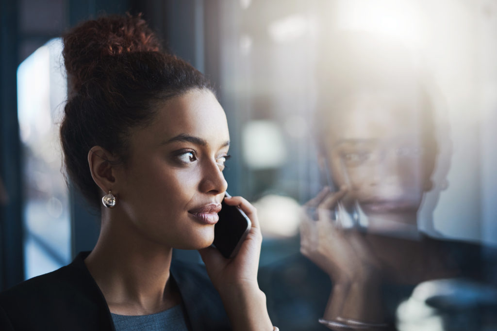 Young businesswoman talking on a cellphone in an office.