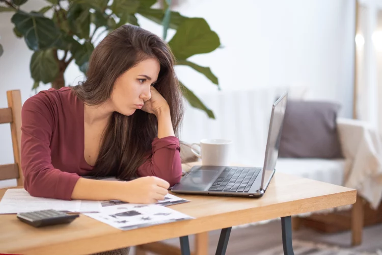 frustrated woman working on laptop