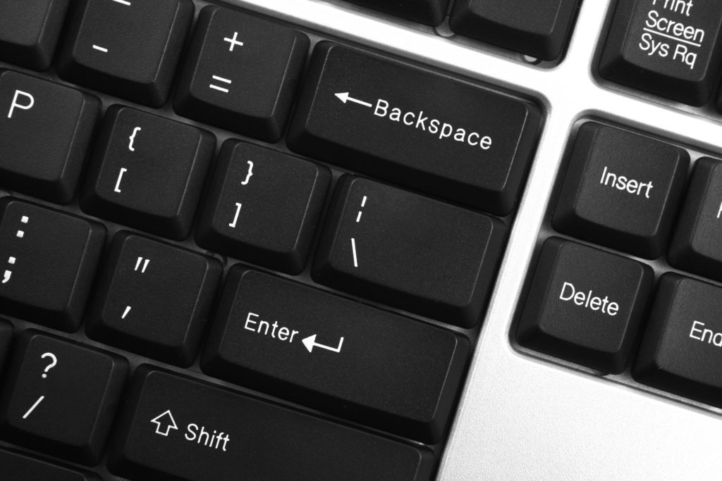Computer keyboard showing the 'Enter', 'Shift' and 'Backspace' keys.