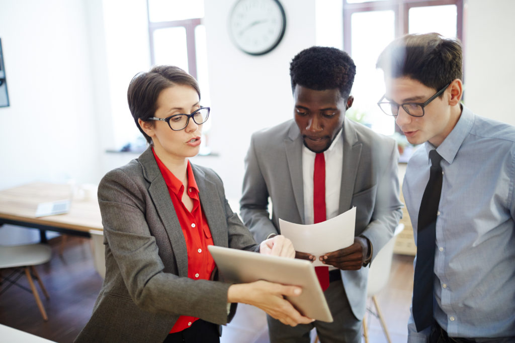 Confident boss explaining project to her employees.