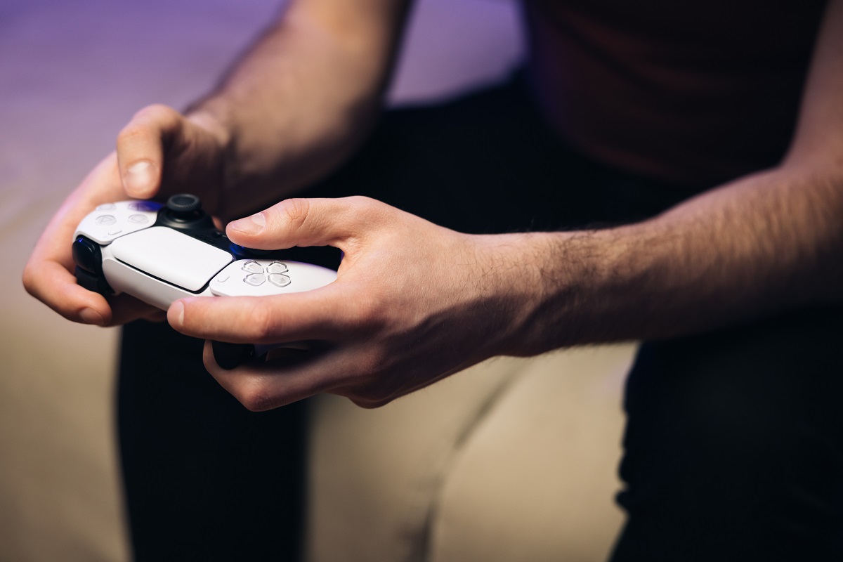 Man playing video game console on smart screen.