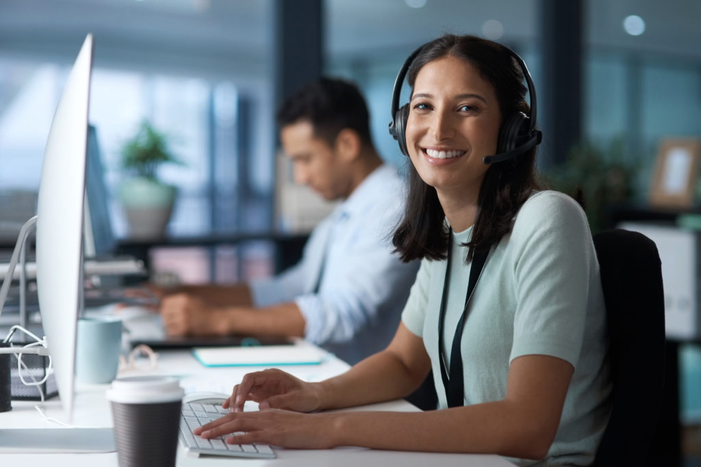 Technical support representatives at their workstations. 