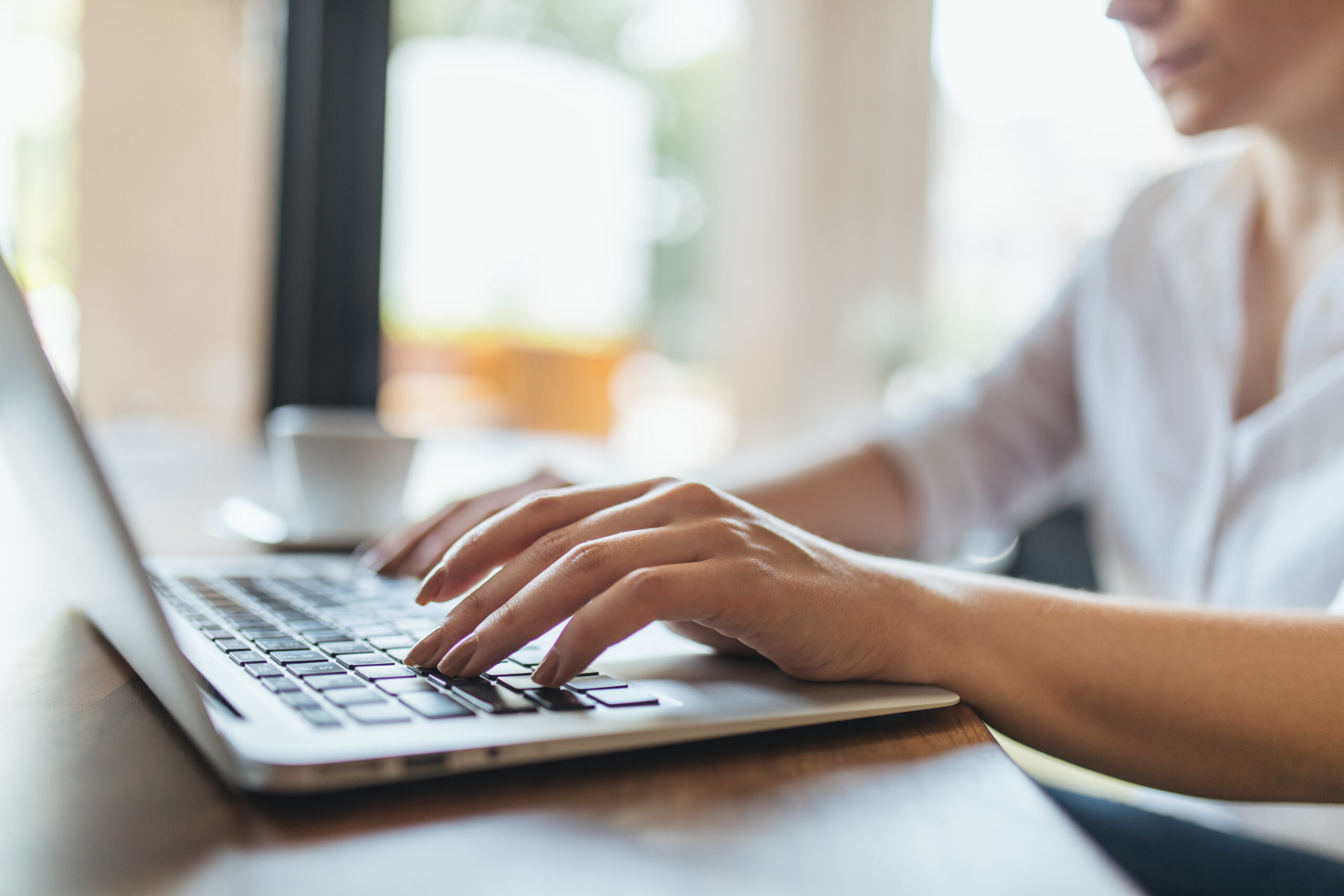 woman writing a message on her laptop