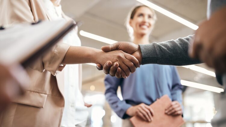 business partners handshaking after successful agreement in office.