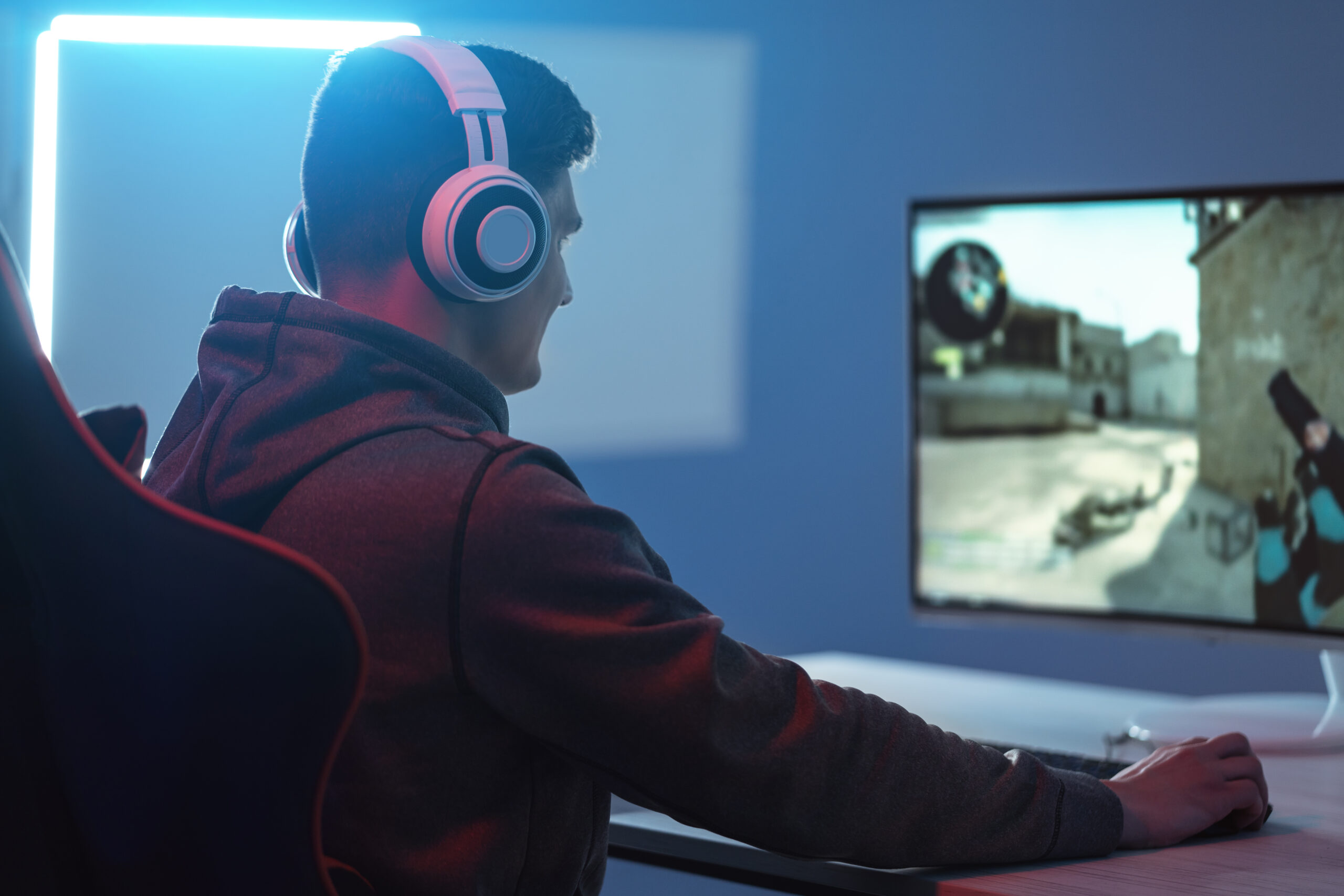 The gamer playing video game on his personal computer