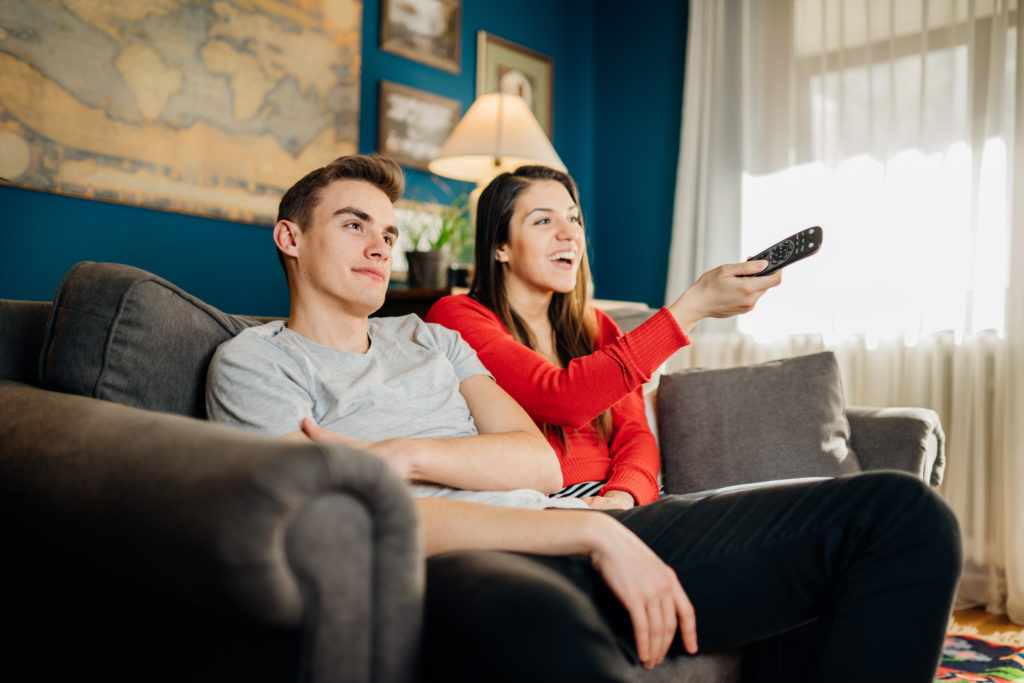 Couple enjoying a television show.