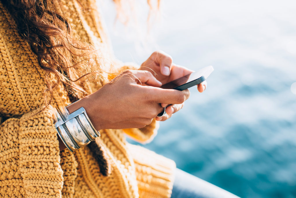 Young female hands texting on smartphone.