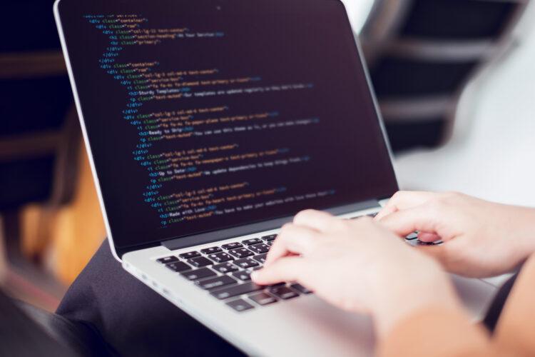 coding on screen, female hands coding html and programming