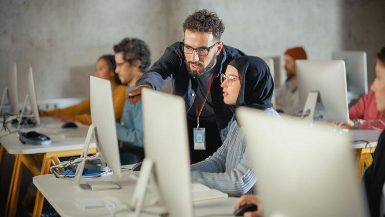 Lecturer helping a student with a project, advising on student's work