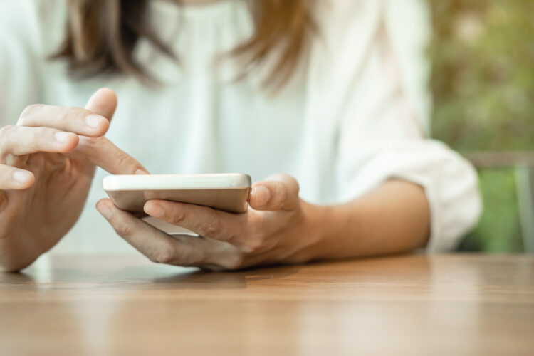 Young woman surfing internet on her smartphone