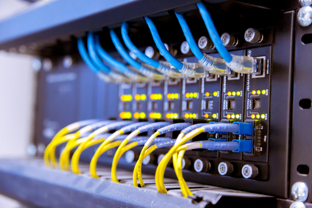 Network switch and ethernet cables in a data center.