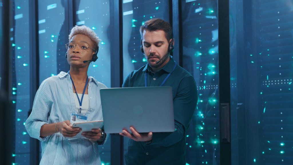 Data center specialists inside a server room.