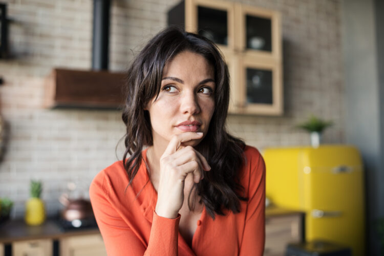 Woman thinking about something at home.