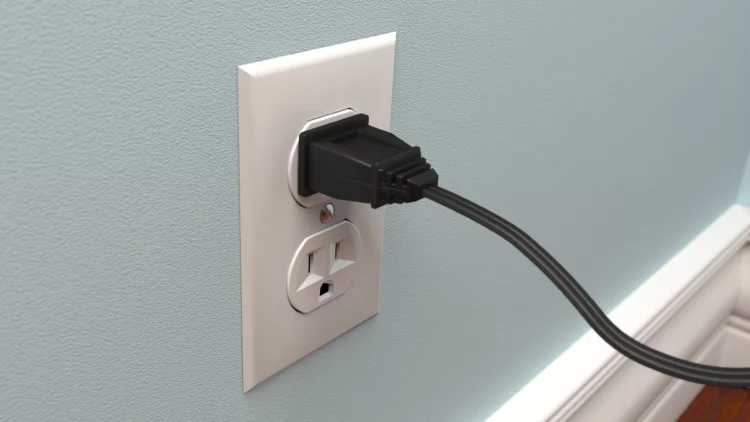 Power cord plugged into wall outlet