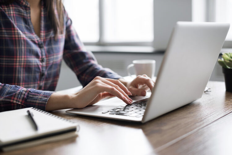 Woman typing on computer keyboard 