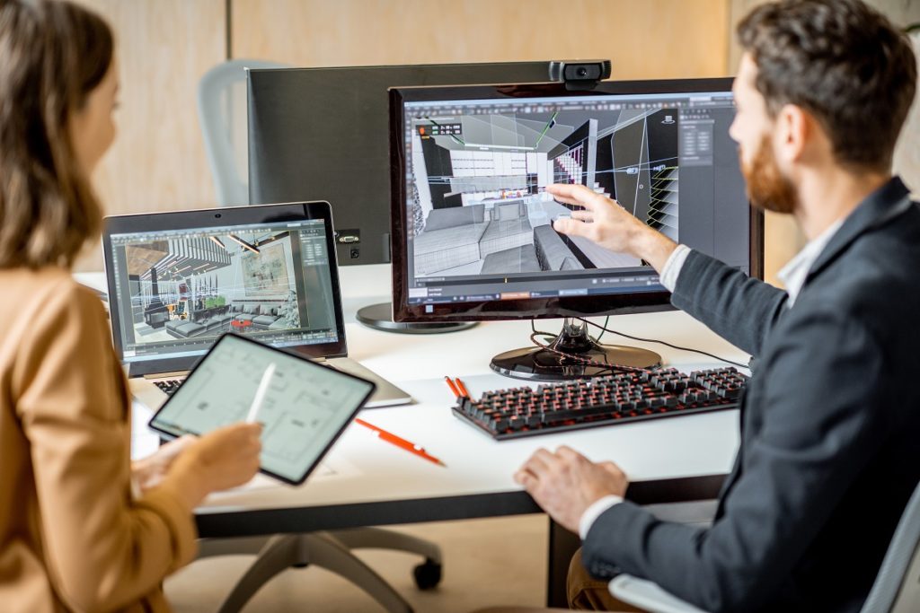 Two interior designers working on their desktop.