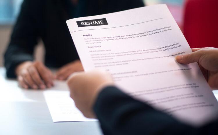 HR personnel holding the resume of an applicant