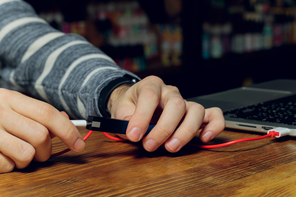 E-cigarette charged using laptop.