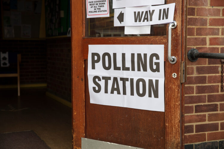 Polling station sign outside the entrance to a political voting location.