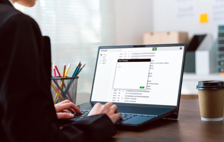 woman writing an email at work