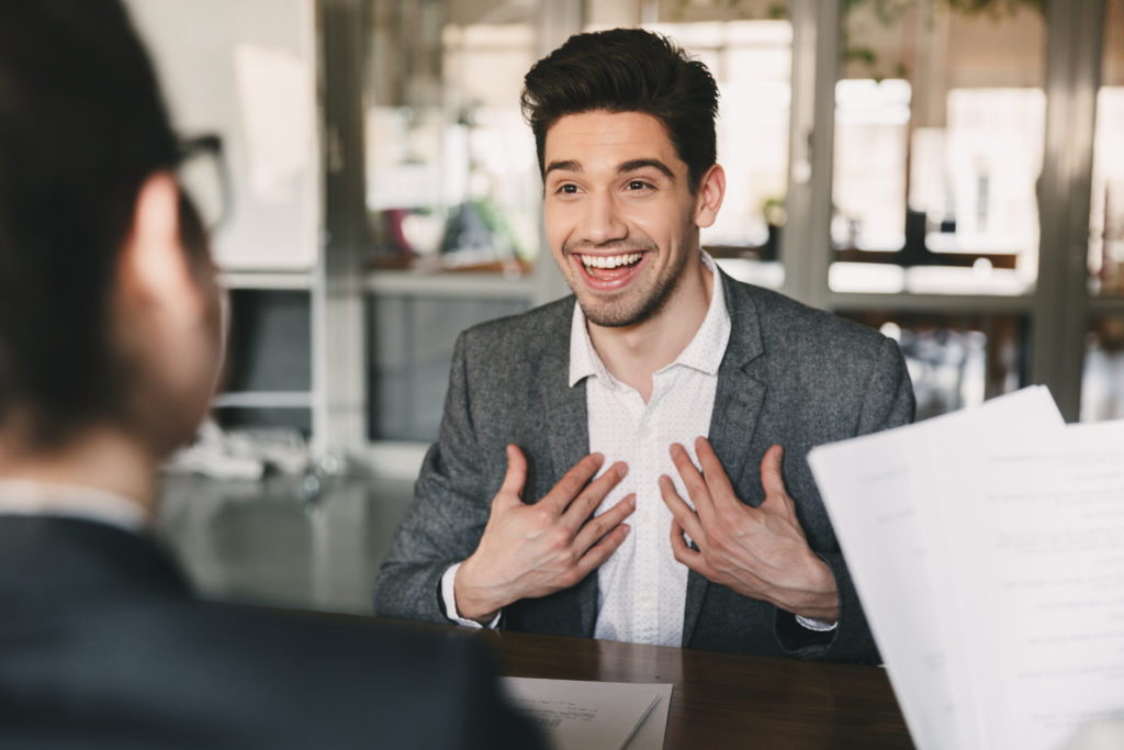 Enthusiastic man having a job interview.