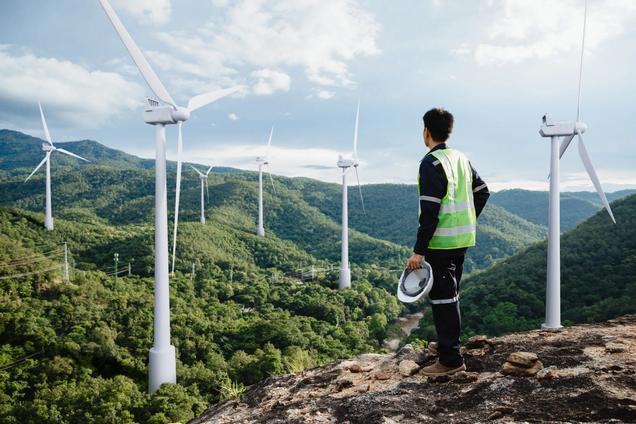young maintenance engineer man working in wind turbine on the mountain