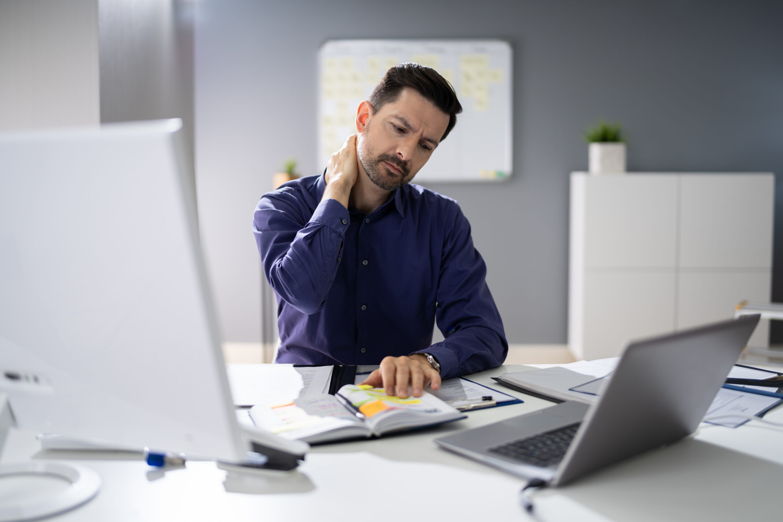 Businessman Suffering From Neck Pain