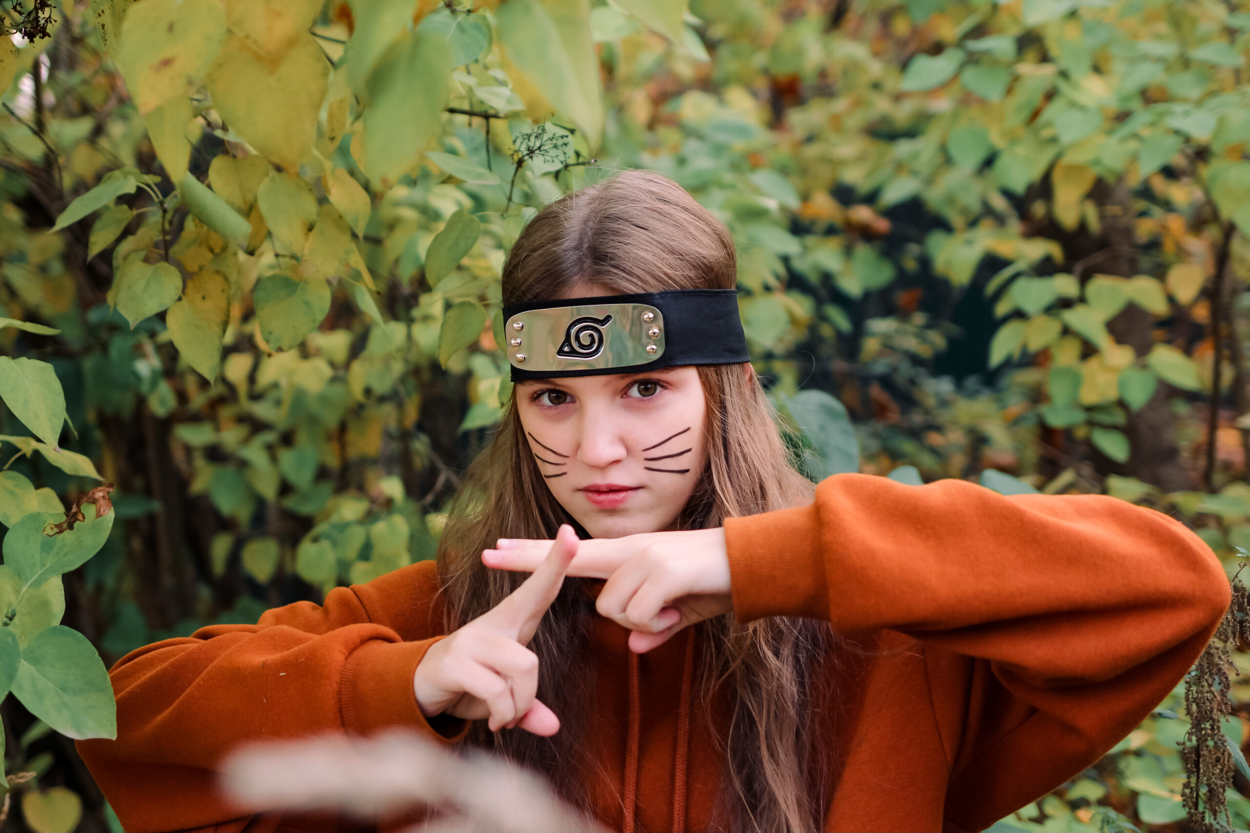 young female cosplayer in Naruto's character