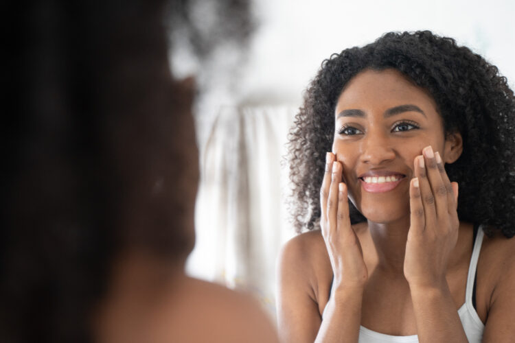 woman looking at herself in the mirror