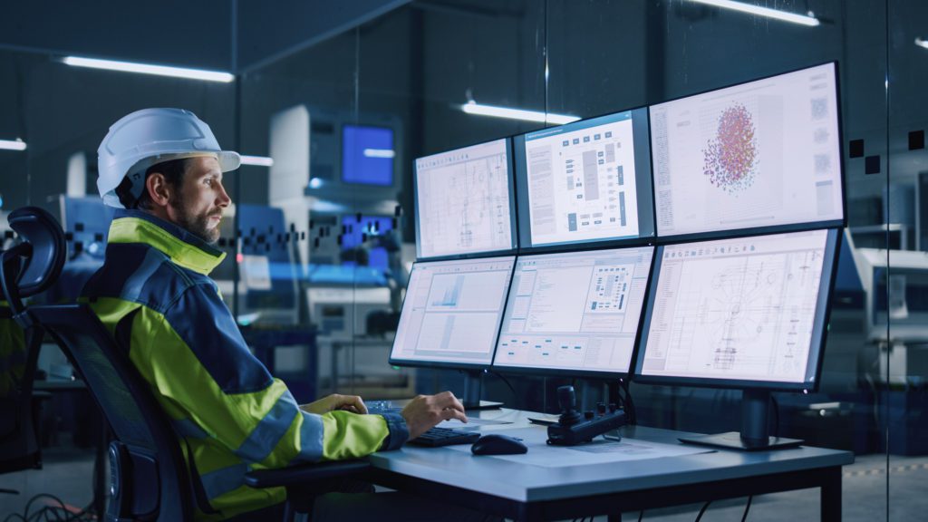 Facility operator using computer to control machinery.