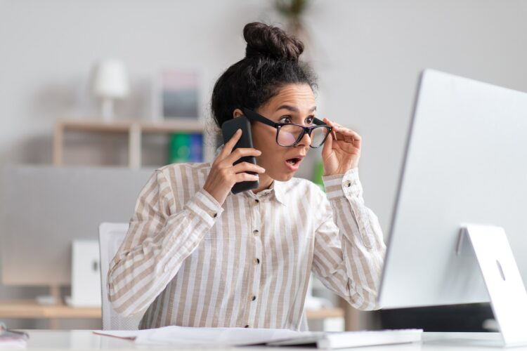 Woman having problems with computer at work.