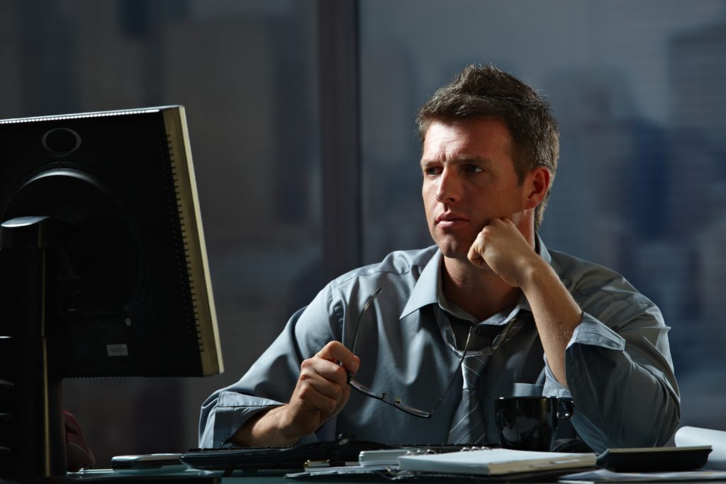 Focused businessman working late at night inside the office.