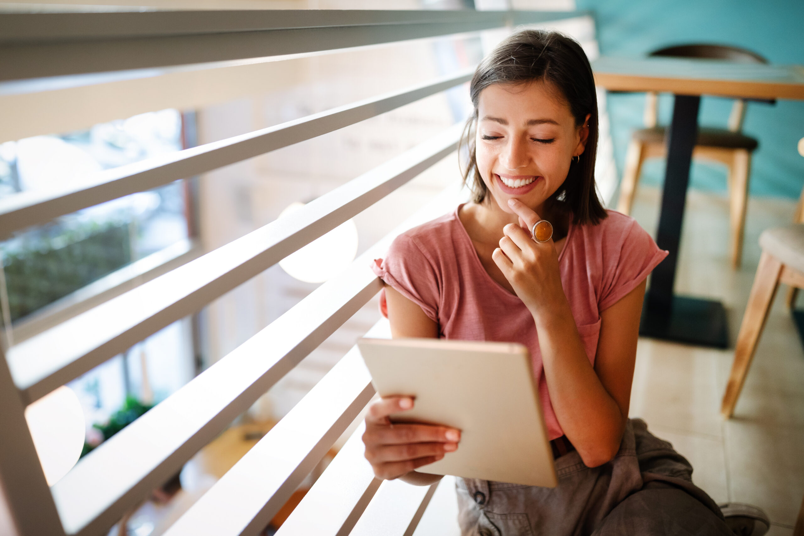 Happy young woman using her digital tablet