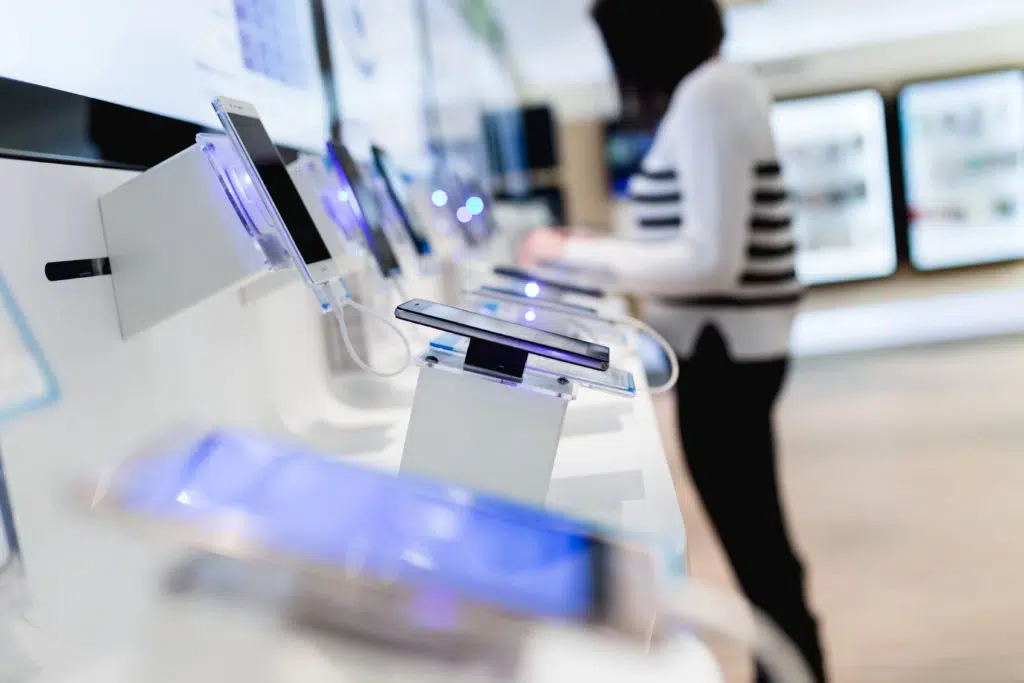 Woman shopping for a smartphone at a local electronics shop.