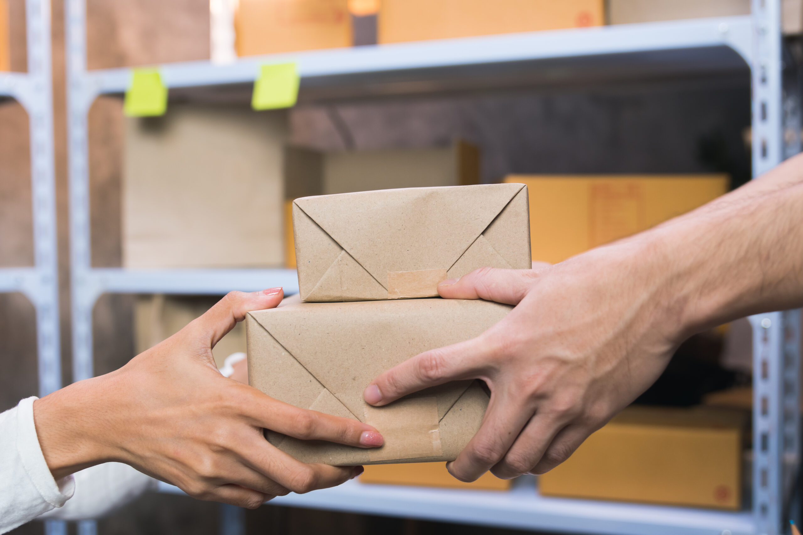 man picks up the parcel at the counter