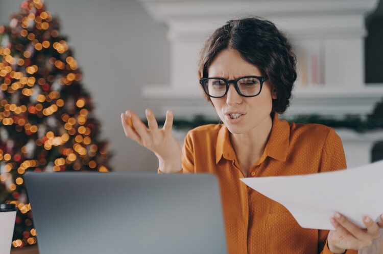 Stressed woman feels angry looking at laptop monitor