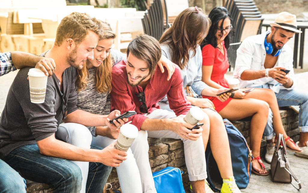 Group of college students using their smartphones.