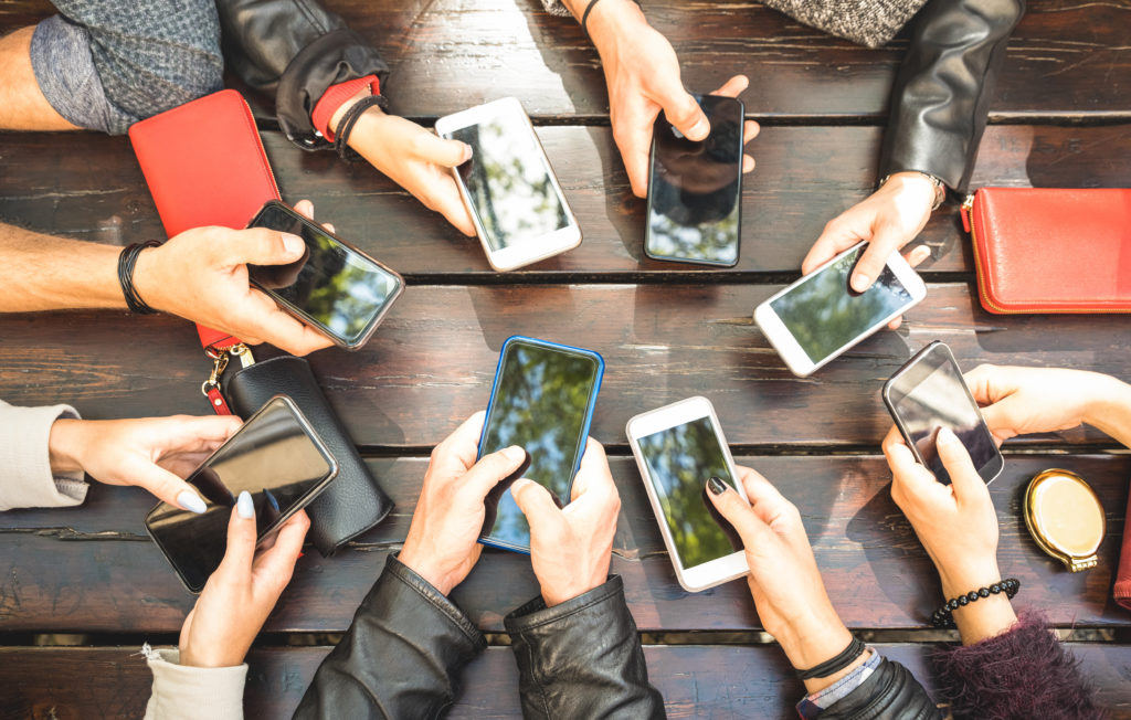 Group of people using smartphones together.