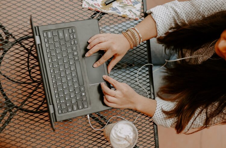 Young woman working with the computer in the cafe.