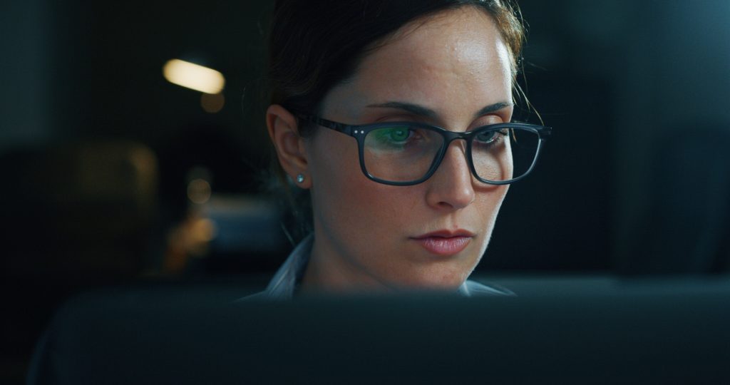 Beautiful office female employee working with a computer.