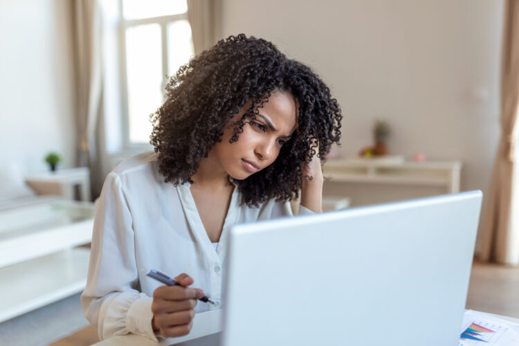 Confused annoyed woman working on desktop computer.